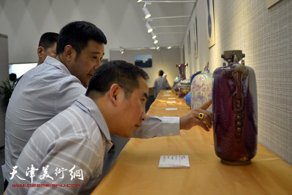 图为赵彦龙、杨廷玺在展览现场观赏钧瓷。