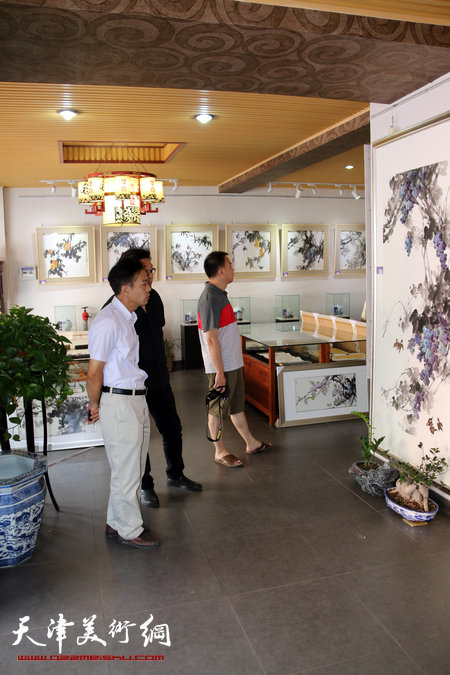 郭德岺花鸟画展26日在艺缘斋开幕，图为来宾观赏画作。