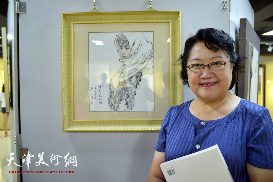 “画韵书香”天津人民美术出版社建社60周年职工书画作品展8月14日在天津人美艺术展厅开幕。图为刘正在其作品《新疆写生》前。