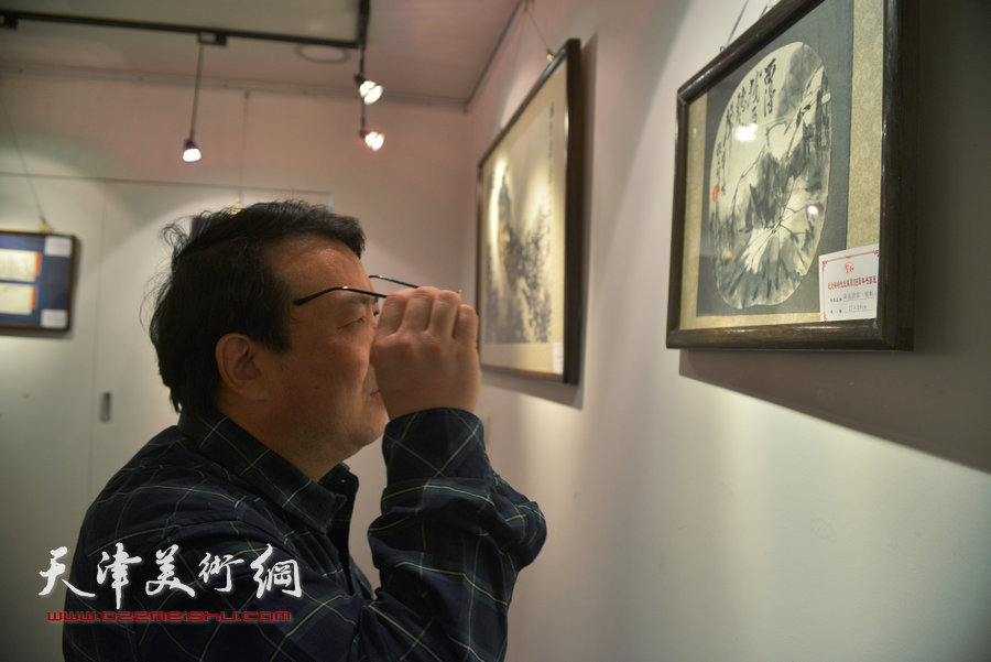 图为王卫平观看梁崎先生精品书画展。