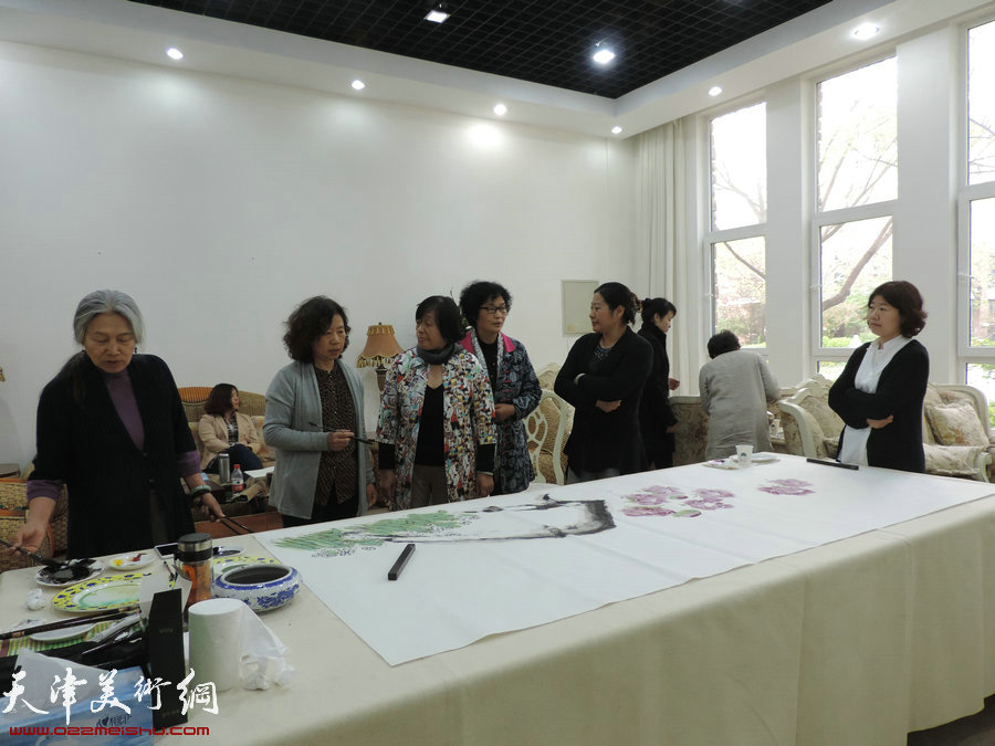 图为女画家在展前笔会上。