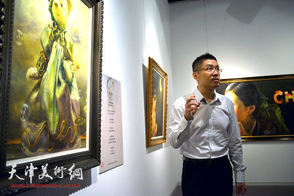 程亚杰在布展现场向记者介绍作品。