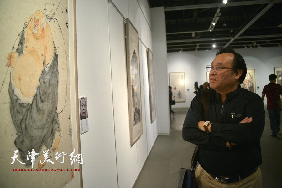陈钢在画展现场观赏作品。