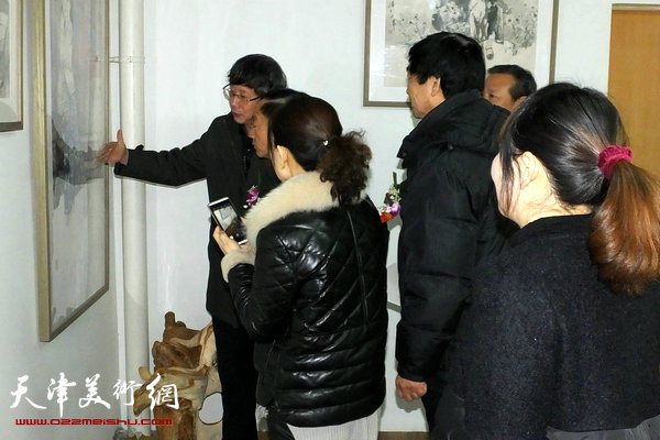 图为王春涛在画展现场为观众讲画。