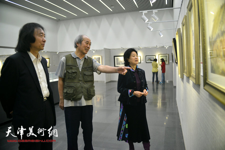 曹秀荣、刘新华、宋家褆在观赏画作。