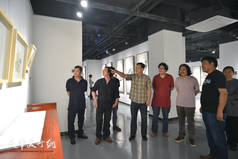 贾广健、张桂元、晏平等在观看展出的作品。