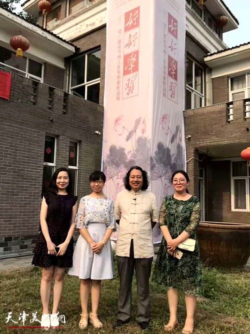 贾广健与天津美术学院硕士研究生主峰、王洛丹、张慧在画展现场。