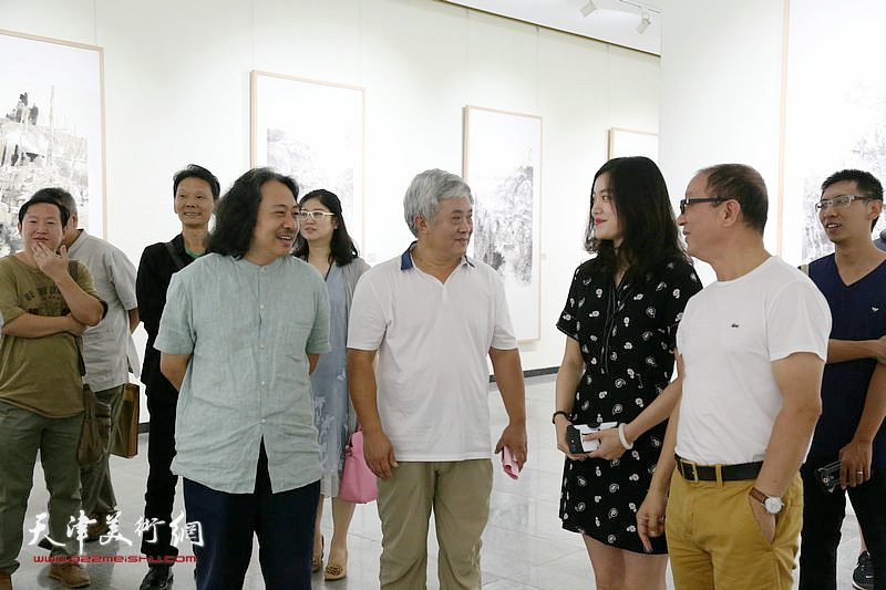 贾广健与各地嘉宾、画家在画展现场。