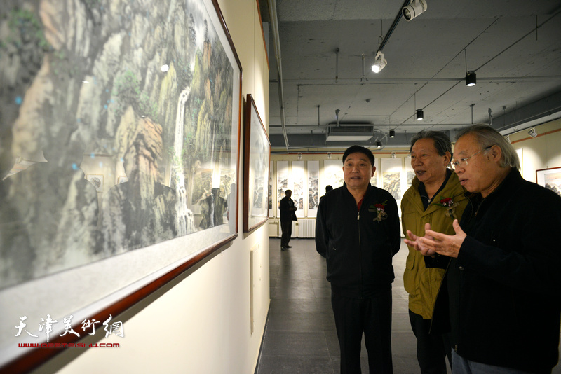 霍然、王金厚、杨海清在观赏展出的作品。