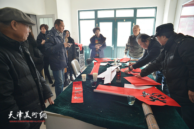 洪喆文化书画院书画家在社区写福字。