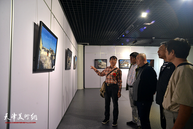 齐宝成与来宾在观赏展出的作品。