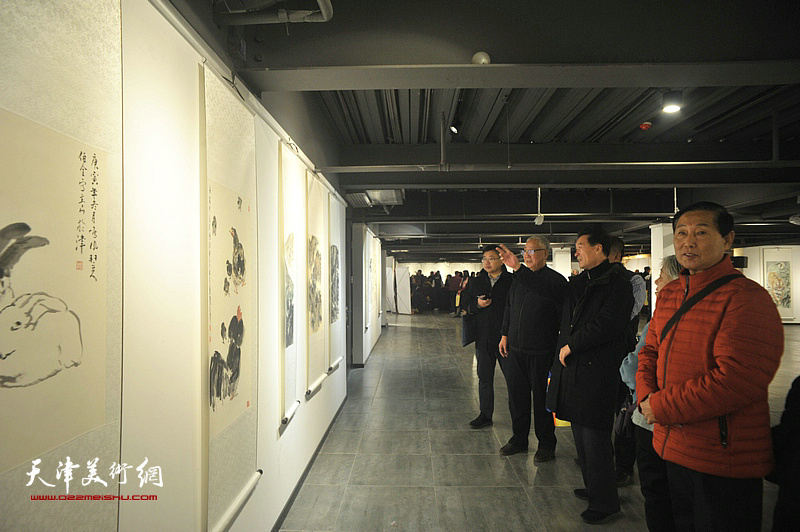 钱桂芳、陈之海与来宾一起在画展现场观看作品。