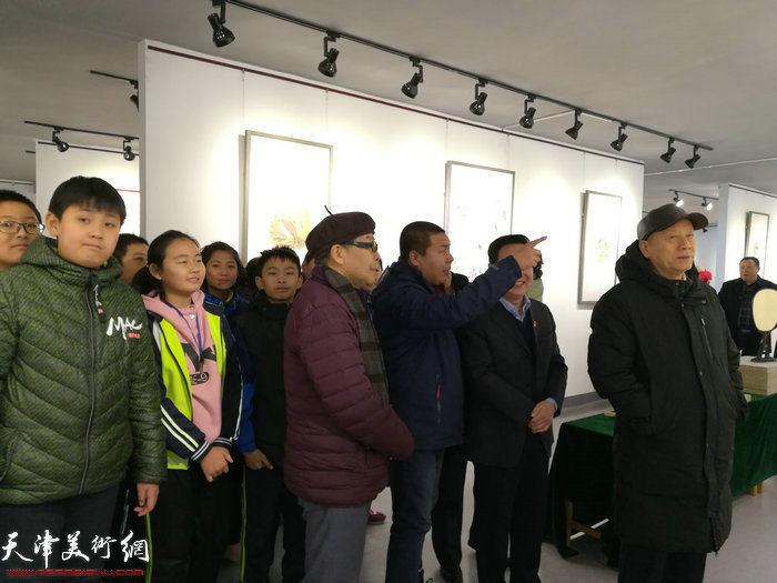 赵余钊在画展现场向嘉宾介绍展出的作品。