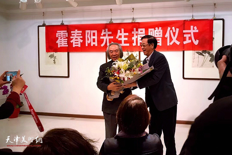 陈列伟在捐助仪式上向霍春阳先生献花。