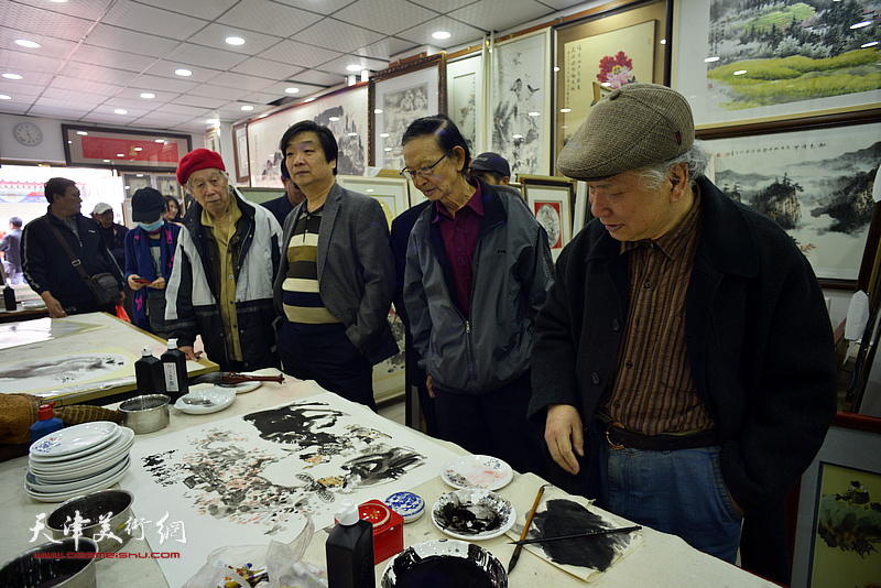 李风雨、房师武、翟洪涛在画展现场创作。