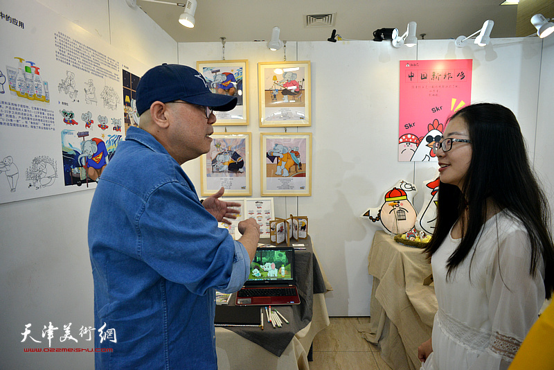 张兵在毕业作品展现场与参展作者交流。