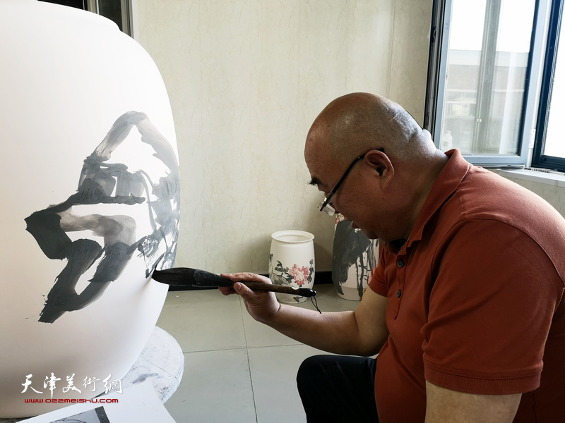 著名书画家尹沧海在北方陶艺中心创作青花瓷。