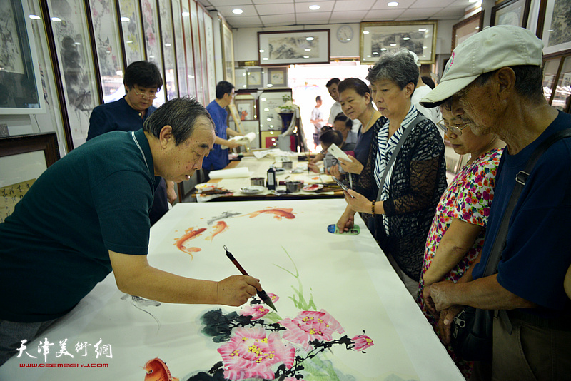 贾春明在鹤艺轩创作巨幅花鸟画《富贵有余》图。