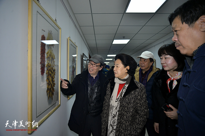 庞恩昌向曹秀荣介绍展出的作品。