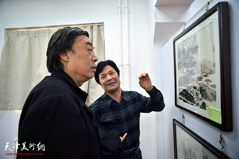 杜晓光、王会清在画展现场观看作品。