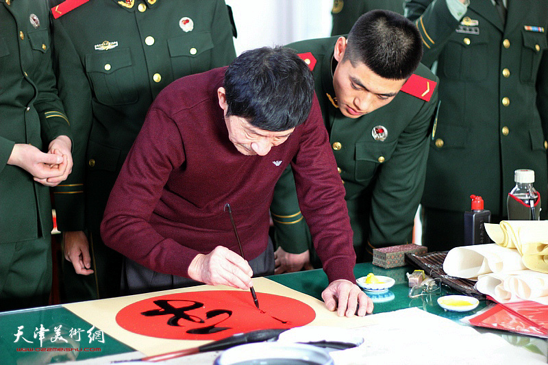 李震在慰问武警战士活动现场写福字。