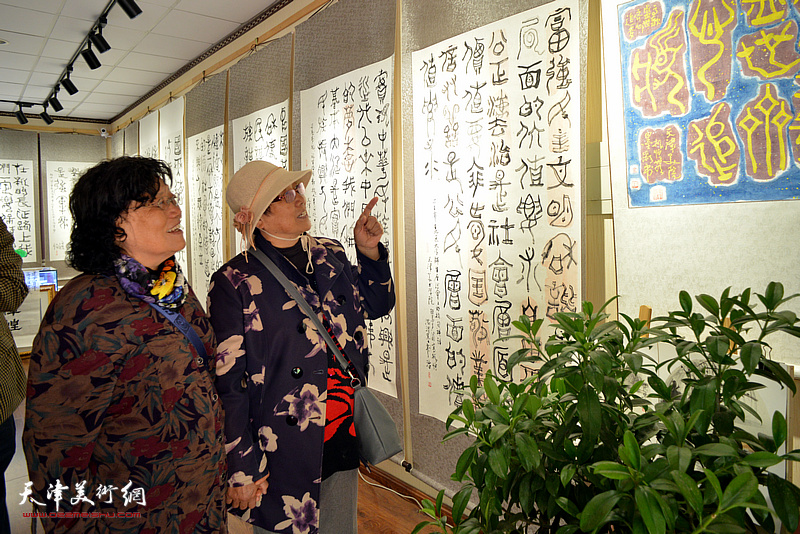 袁桂兰、陈玉梅在观赏展出的高振恒书法作品。