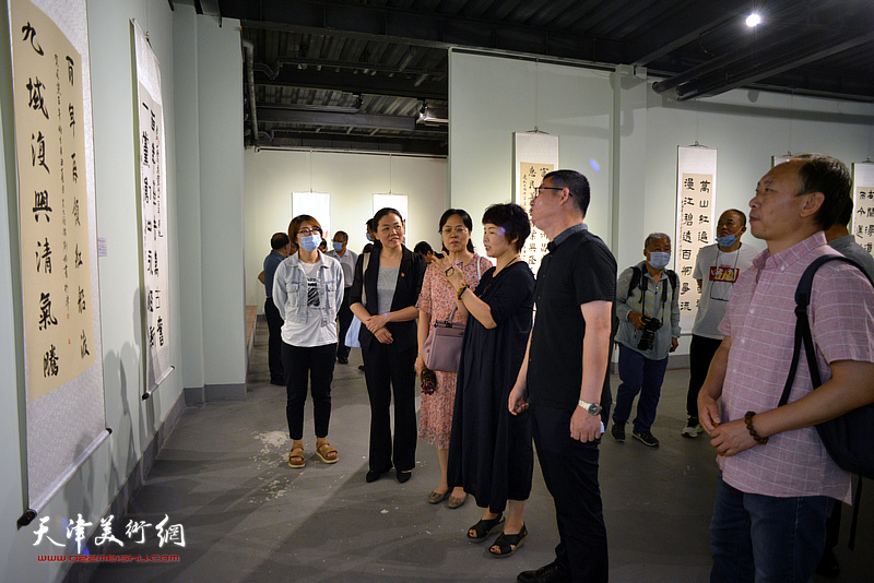 邢纪庆与部分参展书画家观看展出的作品。