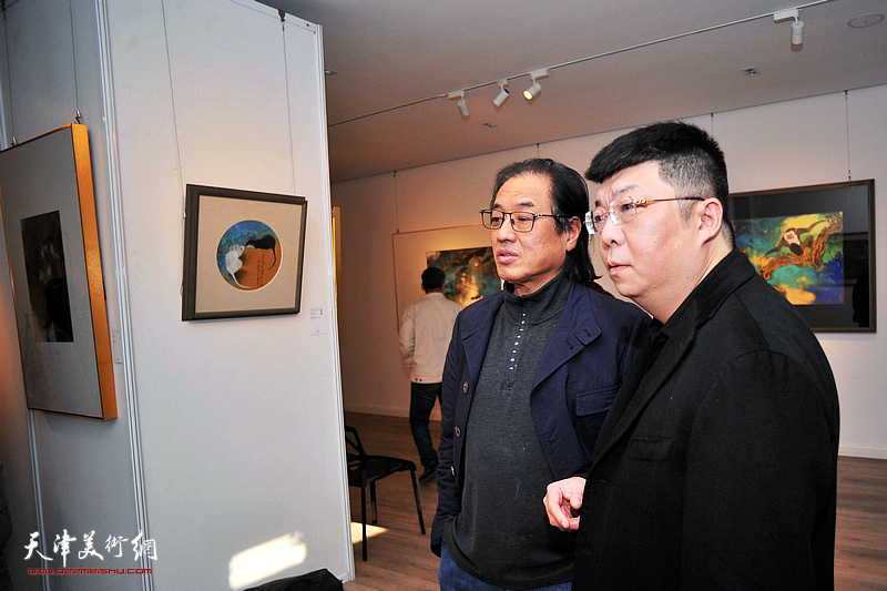 李博隽陪同景育民观赏展出的作品。