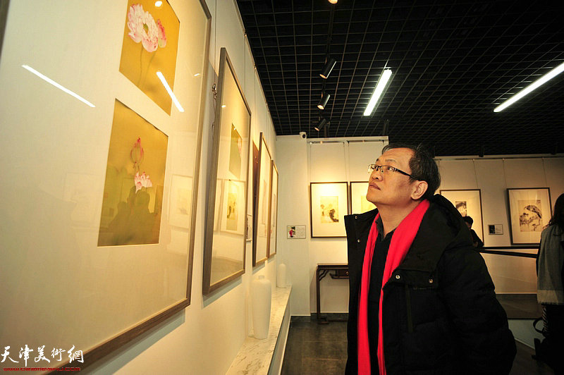 杨惠东观赏展出的作品。