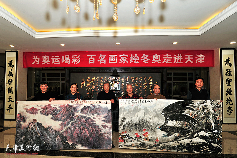 “百名画家绘冬奥”走进天津，图为参加现场活动的艺术家展示为冬奥会创作的山水画作《飞向未来》、《塞外雄关》。