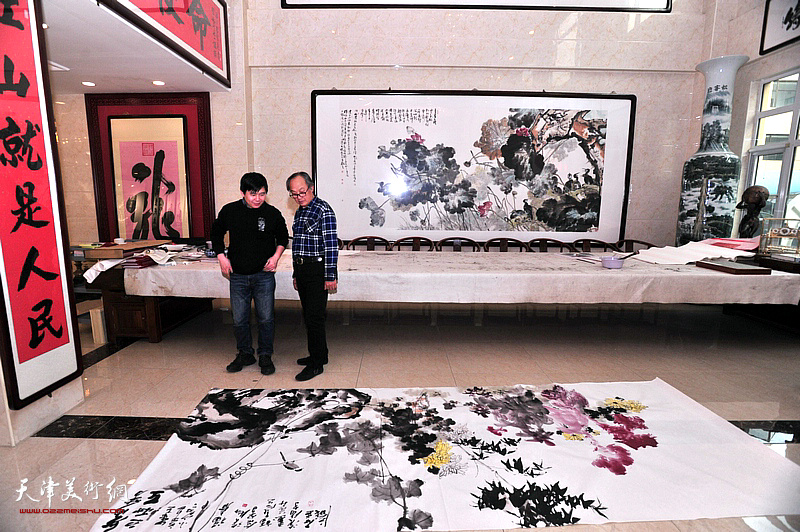 陈福春、陈志峰在宏达热力艺术馆观赏创作的作品。