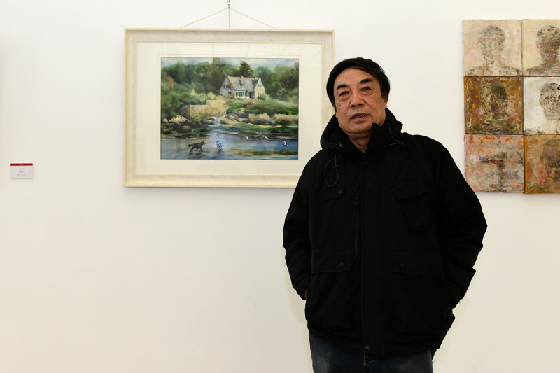 参展画家杜晓光在展出的画作前